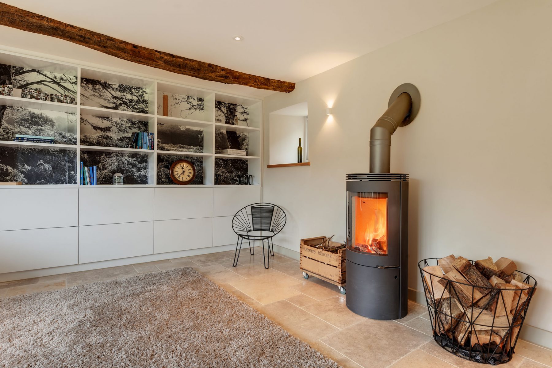 Westfire woodburner in sitting room with library joinery wall, and limestone floor.