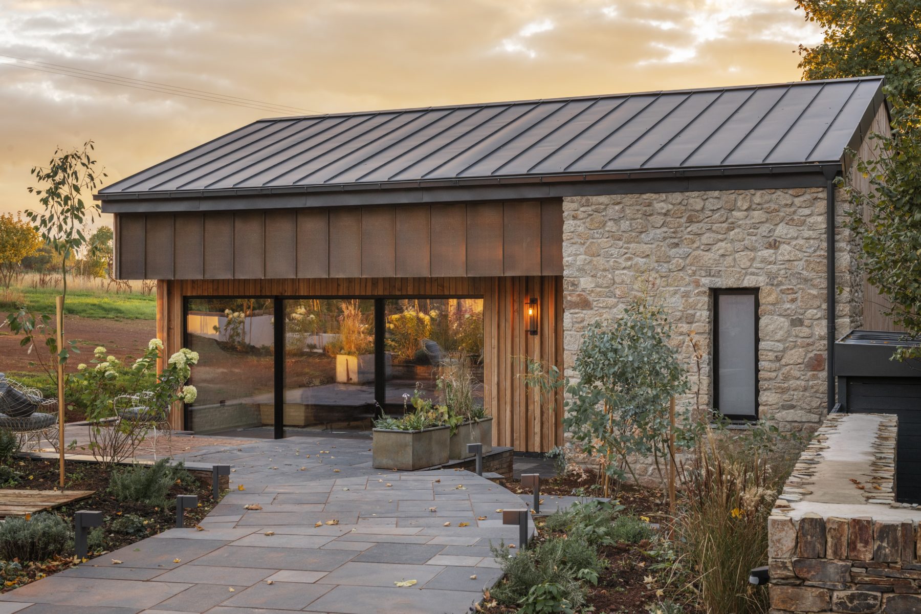 View of the garden and patio and windows of Higher Dorsley in Devon