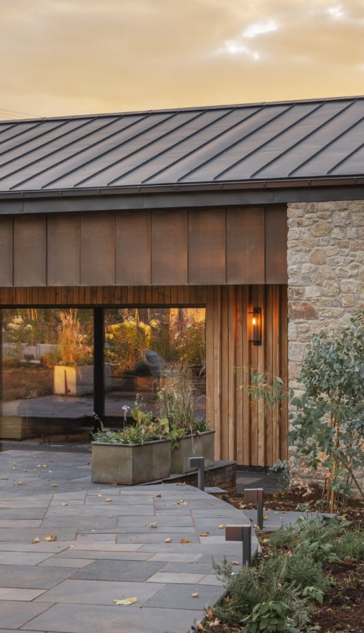 View of the garden and patio and windows of Higher Dorsley in Devon