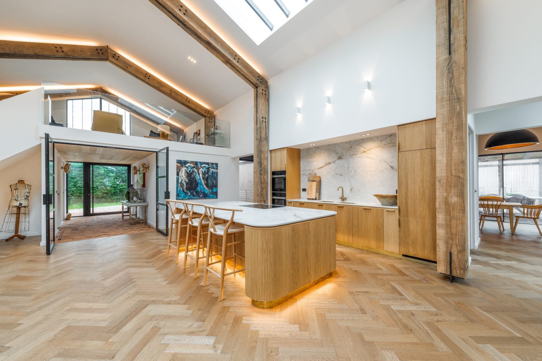 View of a island kitchen table and kitchen with wooden floor and low lighting