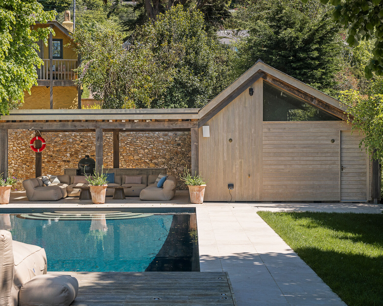 Oak framed pool house with outdoor kitchen and eating area, and natural pool, VESP architects, Dorset